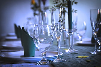 Elegant Banquet Table Setting With Glassware And Green Napkins