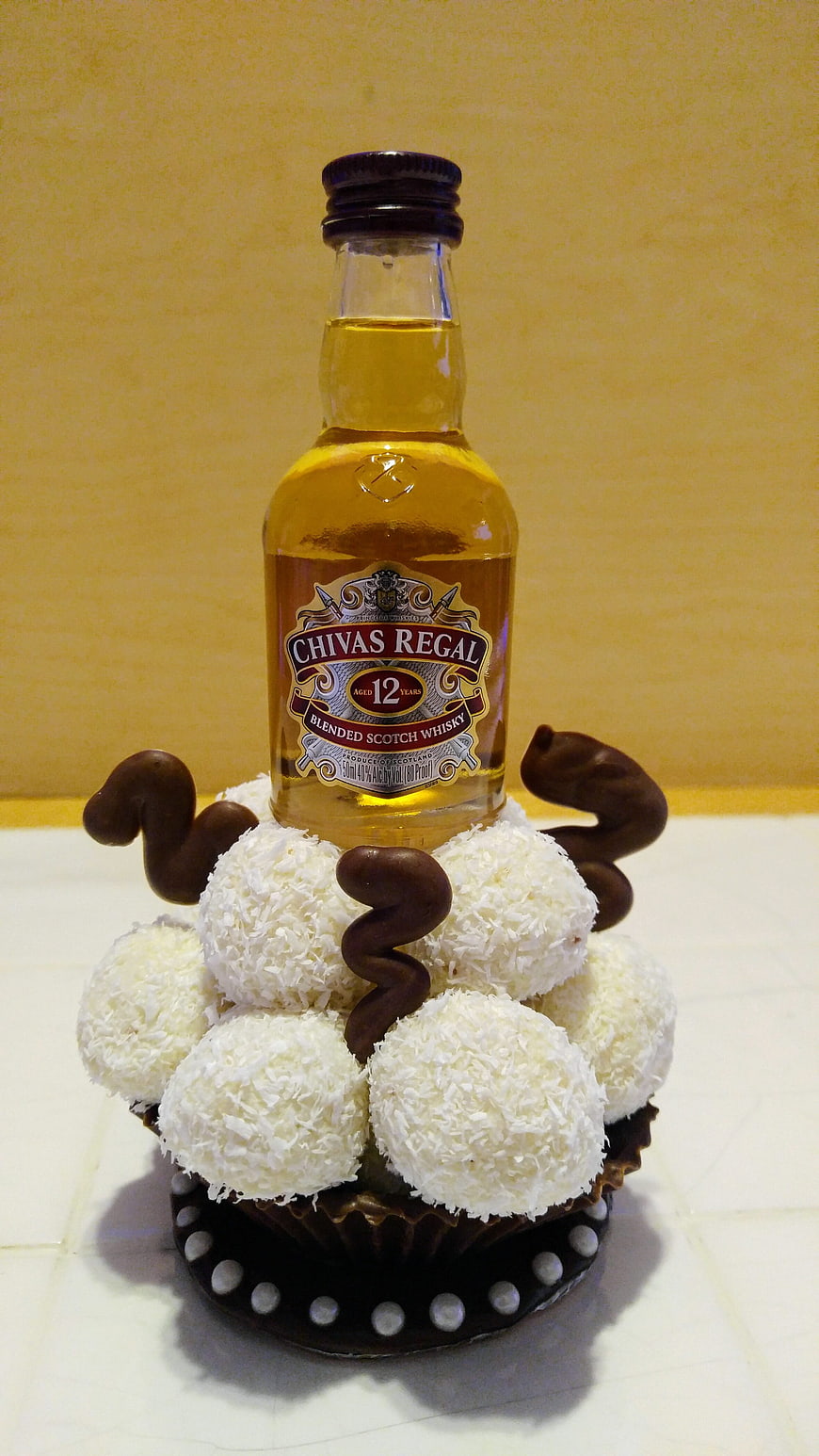 Chivas Regal Whisky Bottle Displayed On Coconut Truffle Cake