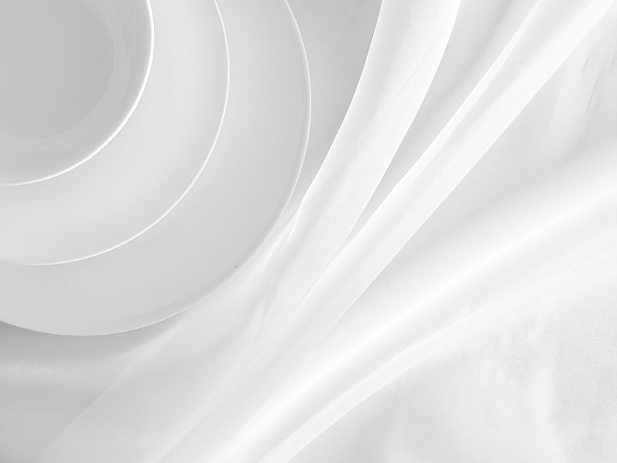 Minimalist White Ceramic Bowl on Flowing Silk Fabric