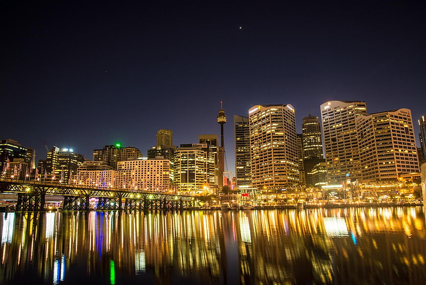 Sydney skyline at night with reflections on water