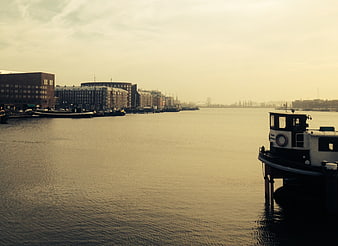 Serene Harbor Scene with Boats and City Buildings
