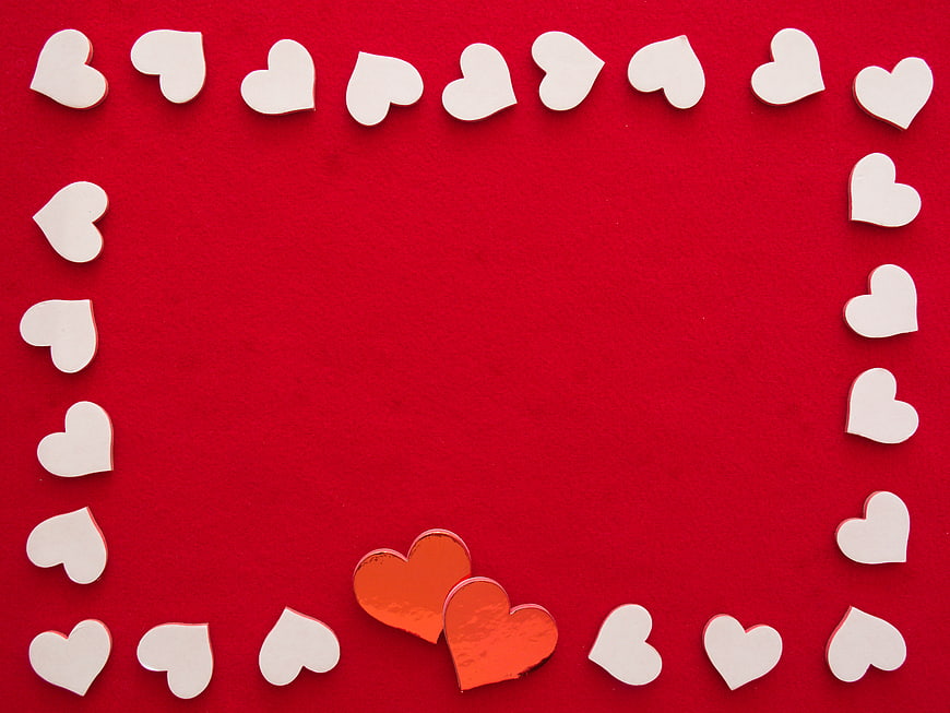 White and Gold Hearts on Red Background with Copy Space