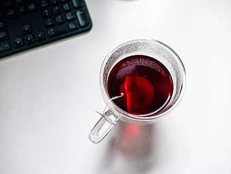 Top View of Red Tea in Glass Cup on White Desk