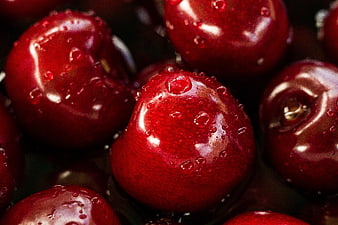 Close-up of fresh red cherries with water droplets