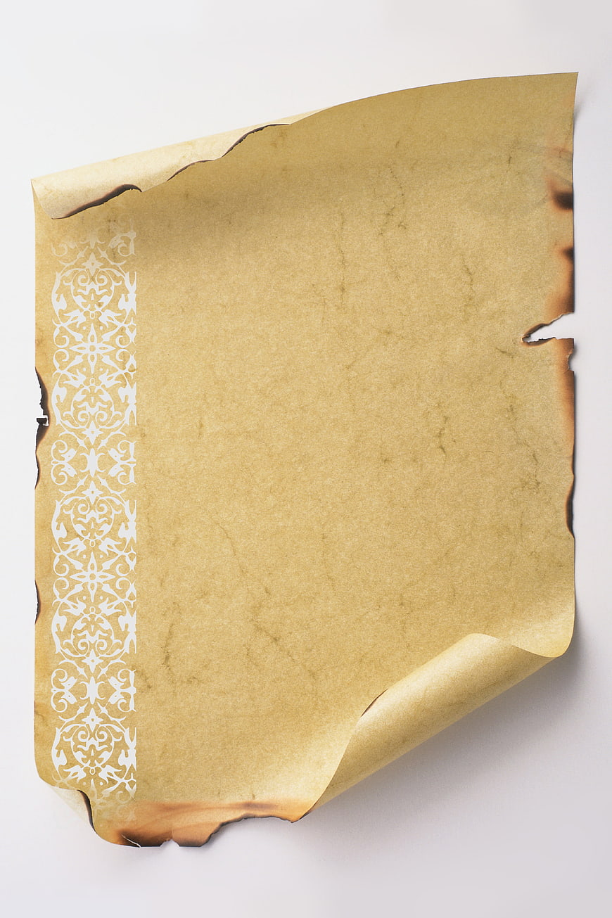 Aged Parchment Scroll with Burnt Edges and Ornate Floral Border