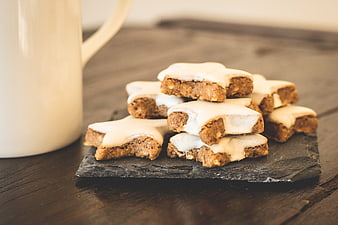 Star-shaped cinnamon cookies with white glaze on slate