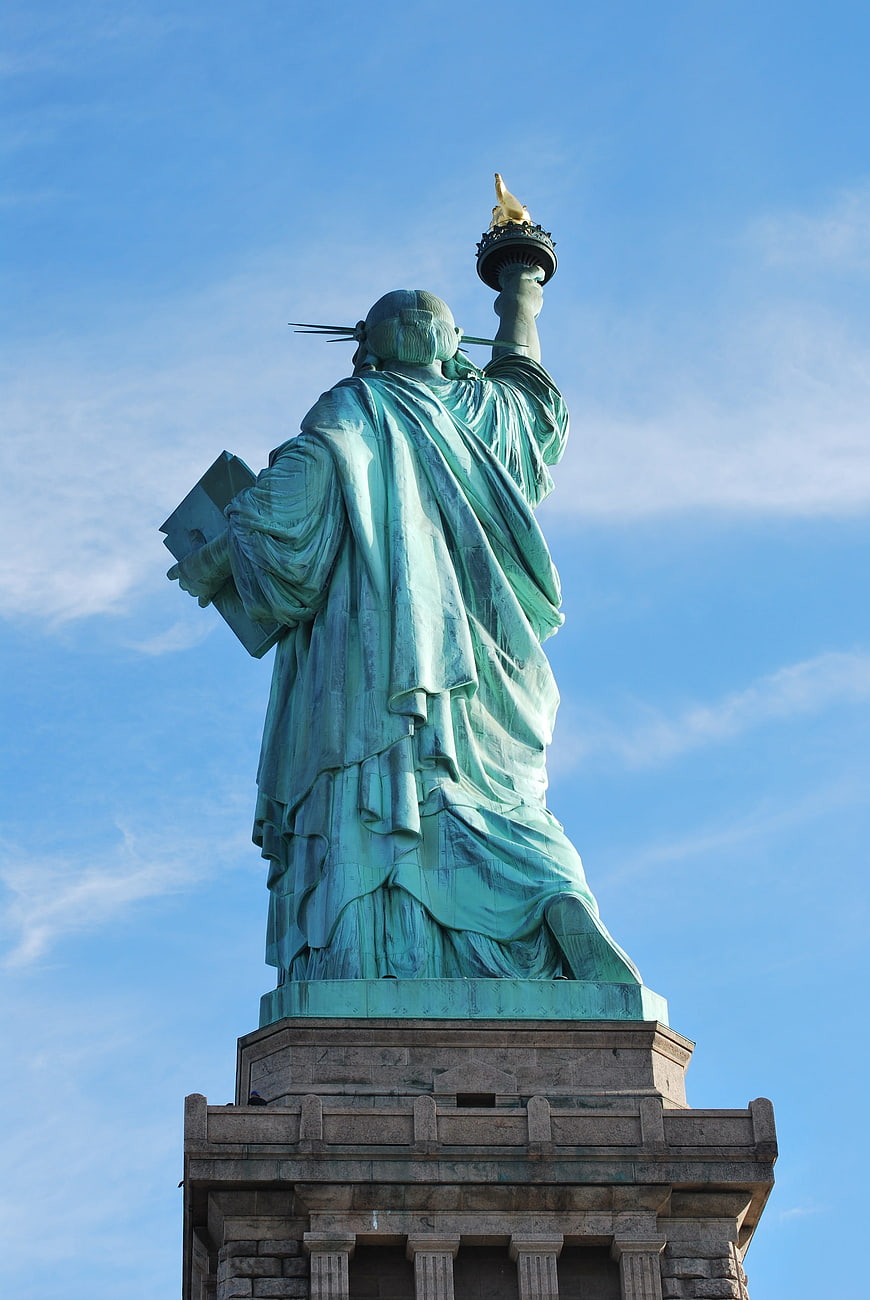 Rear View of Statue of Liberty Against Blue Sky