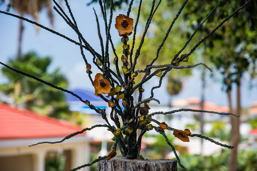 Metal wire flower sculpture in garden setting