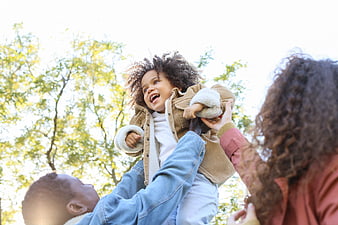 Happy African American Family Playing in Park