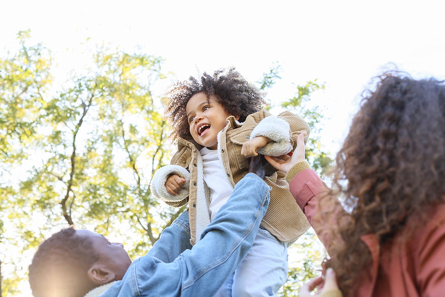 Happy African American Family Playing in Park