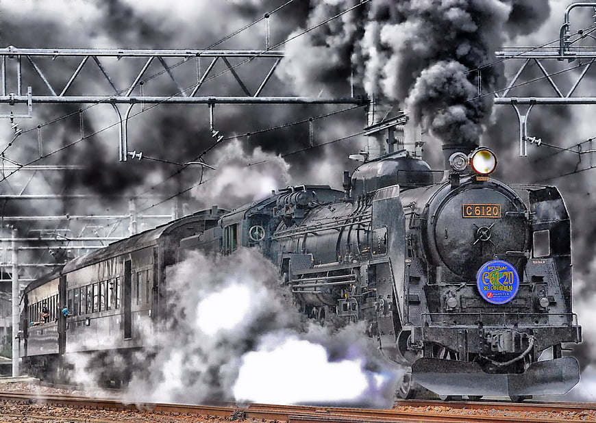Vintage Steam Locomotive Billowing Smoke on Railroad Tracks