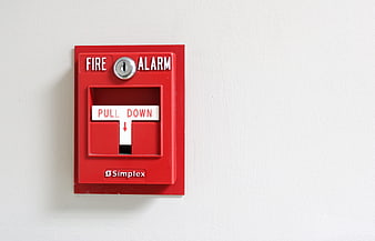 Red Fire Alarm Pull Station on White Wall