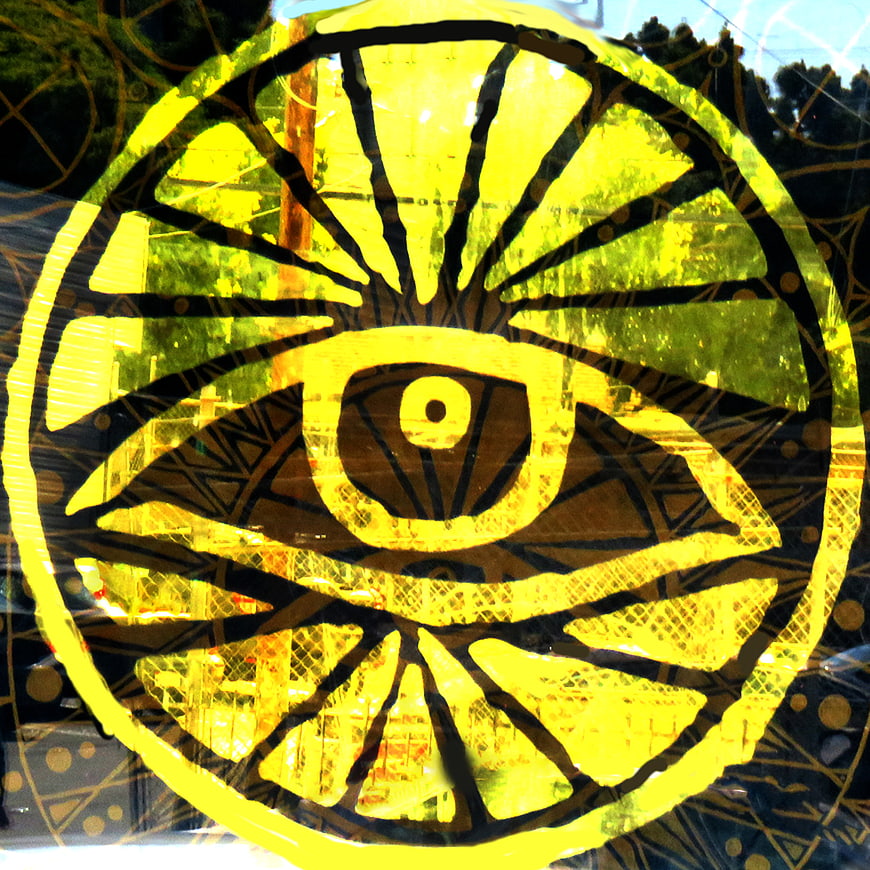 Yellow Evil Eye Symbol on Glass Window