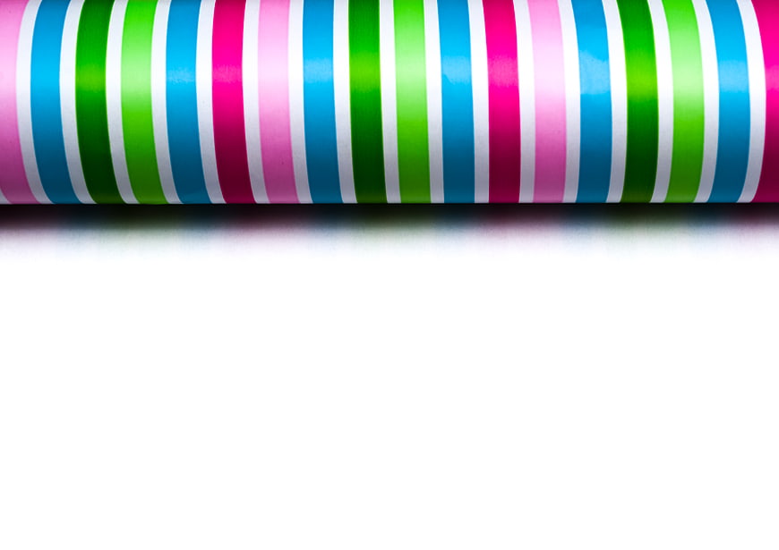 Colorful striped wrapping paper roll on white background