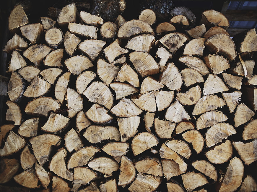 Stacked Firewood Logs with Natural Wood Grain Texture