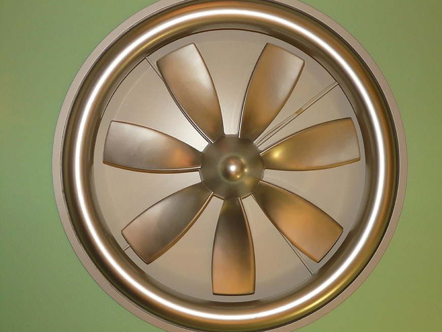 3D Render of Gold Ceiling Fan on Green Background