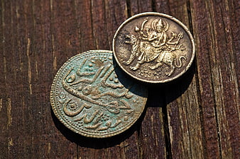 Antique Indian Rupee Coins On Weathered Wooden Surface