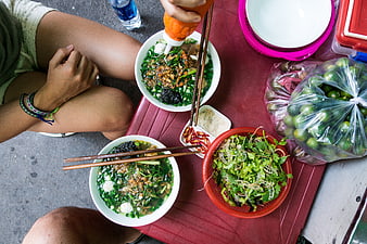 Top view of Vietnamese noodle soup with fresh herbs and lime