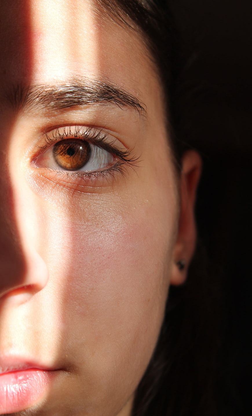 Close-Up Portrait of Woman's Eye With Dramatic Shadow