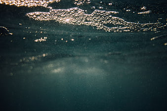 Underwater Ocean Surface with Sunlight and Bubbles