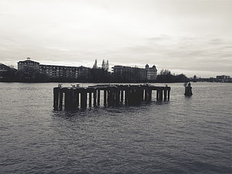 Black and white photo of a wooden pier in a lake