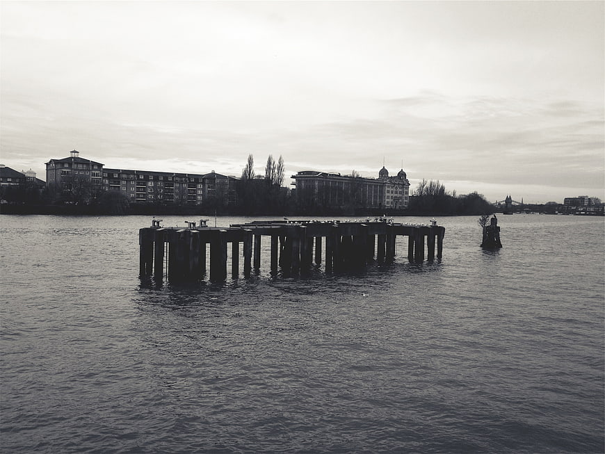 Black and white photo of a wooden pier in a lake