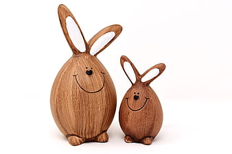 Wooden Easter Bunny Figurines on White Background