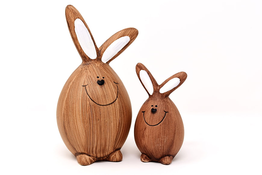 Wooden Easter Bunny Figurines on White Background