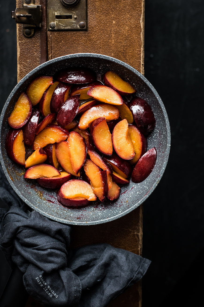 Top View of Roasted Plum Slices in a Pan