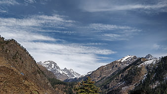 Panoramic View of Snow-Capped Mountain Peaks and Blue Sky