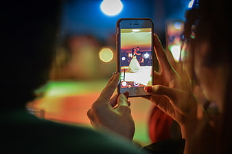 Woman recording wedding first dance on smartphone