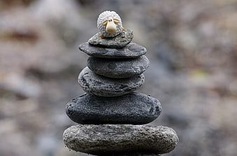 Stacked River Stones With Small Ceramic Sheep Figurine