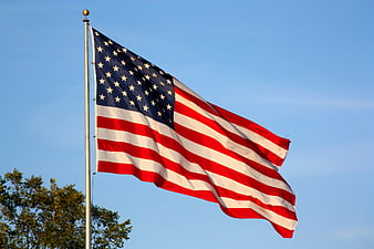 American Flag Waving Against Clear Blue Sky