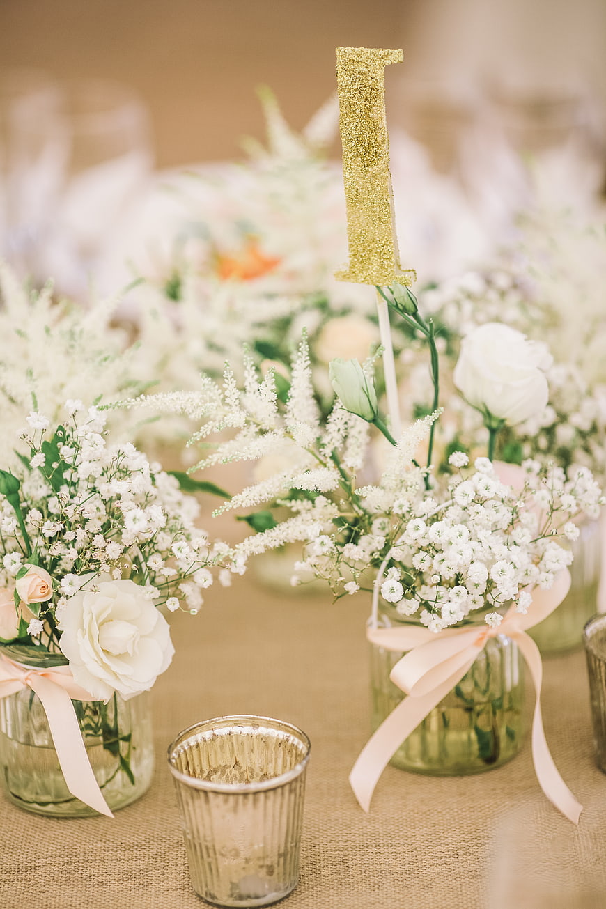 Elegant Wedding Table Centerpiece with White Flowers and Gold Number