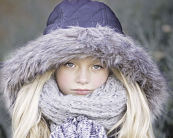 Portrait of a young blonde girl in winter clothes