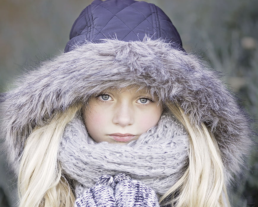 Portrait of a young blonde girl in winter clothes