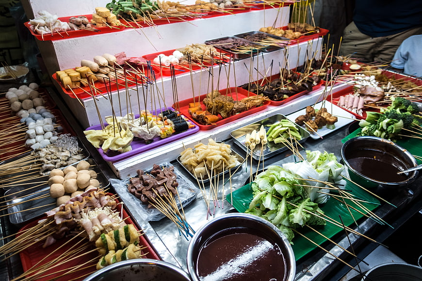 Variety of Malaysian Lok Lok street food skewers and ingredients