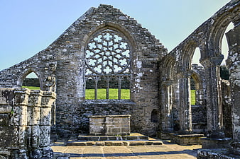 Interior of historic stone chapel ruin with rose window