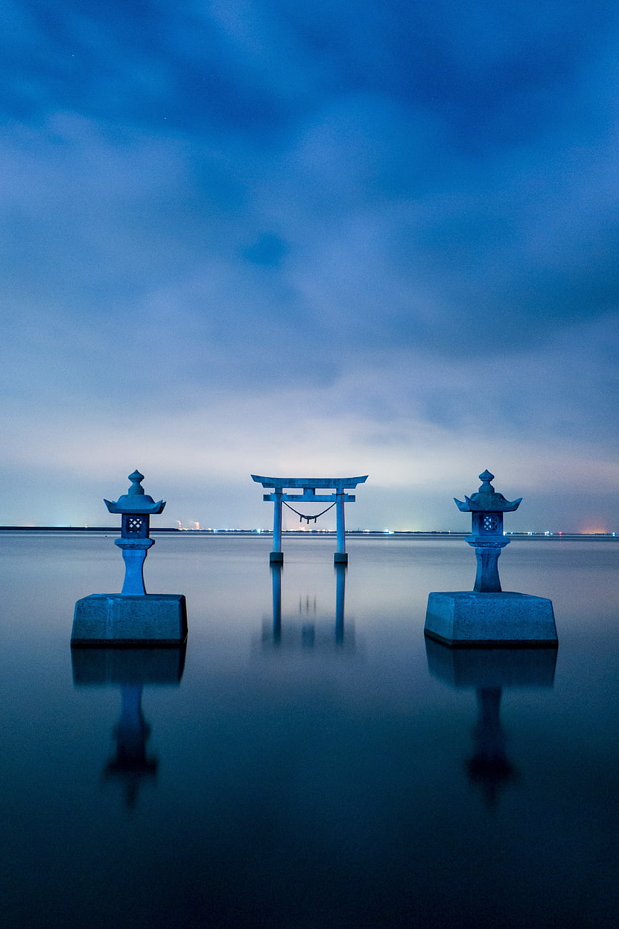 Serene Japanese Torii Gate and Lanterns in Water at Dusk