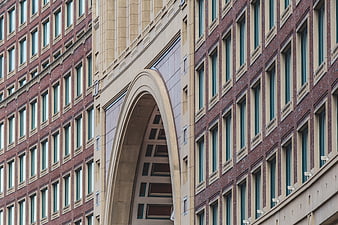 Modern Brick Building Facade with Large Stone Archway