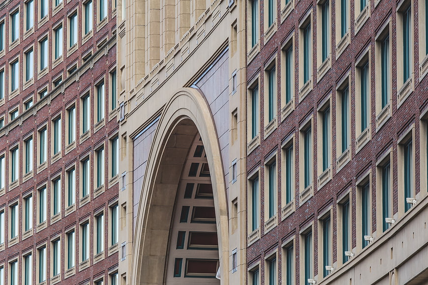 Modern Brick Building Facade with Large Stone Archway