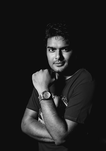 Dramatic black and white portrait of a young man with a watch