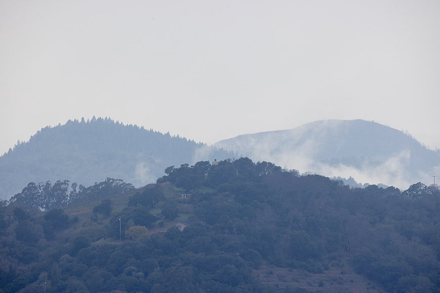 Misty mountain landscape with foggy forest hills