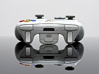 White Xbox 360 Controller on Reflective Surface