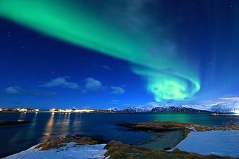 Vibrant Green Aurora Borealis Over Snowy Norwegian Fjord