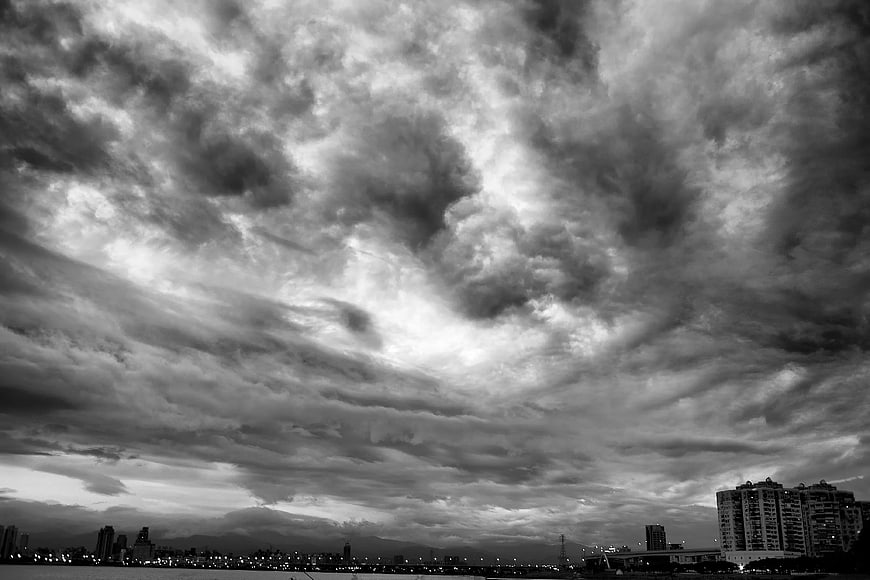 Dramatic Black and White Storm Clouds Over City Skyline