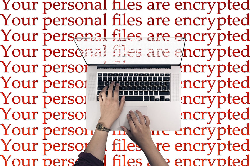 Laptop with ransomware warning text background