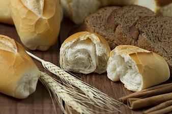Freshly Baked Artisan Bread Rolls With Wheat Stalks And Cinnamon Sticks