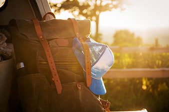 Canvas Backpack with Blue Hat in Golden Sunlight