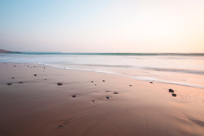 Serene Sunset Beach with Smooth Sand and Gentle Waves